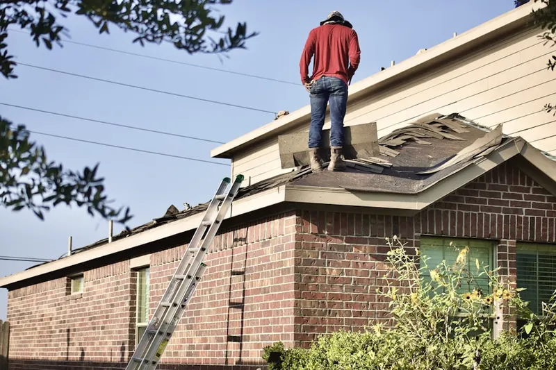 Professional roofer working on a residential roof in Greenland